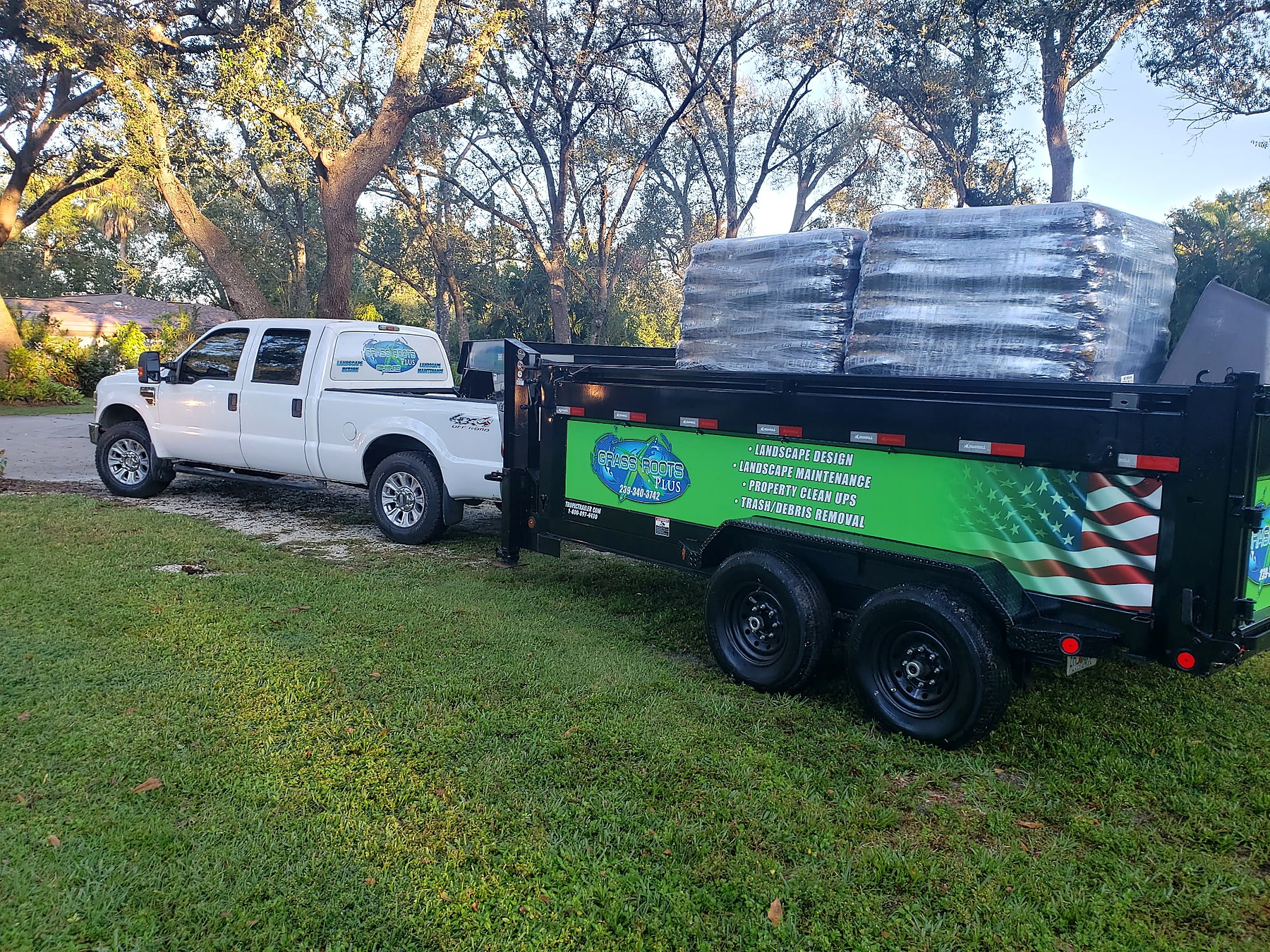 Grass Roots Plus truck and hauling trailer loaded for service